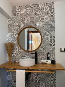 a bathroom with a sink and a mirror at El Tejado de Santa Ana in Barrika