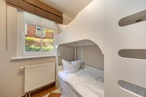 a small bed in a room with a window at Villa Quisisana in Binz