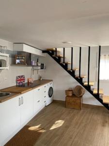 a kitchen with a spiral staircase in a house at La casilla de Vicente in Torres