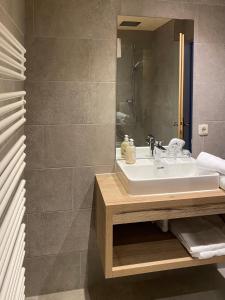 a bathroom with a sink and a mirror at Landhaus Rosengartl Krimml in Oberkrimml