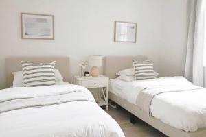 two beds sitting next to each other in a bedroom at The Modern Victorian 200 metres from CBD in Bathurst