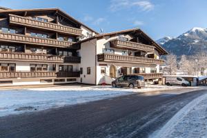 a large building with cars parked in front of it at Haus Excelsior Top 20 in Seefeld in Tirol