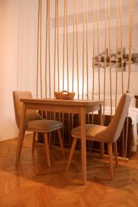 una mesa de madera con 2 sillas y un bol en ella en 16DI, en Kraljevo