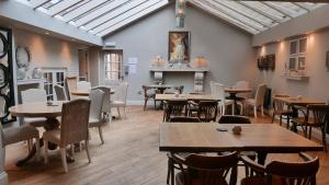a restaurant with tables and chairs in a room at The Boot Inn in Burton upon Trent