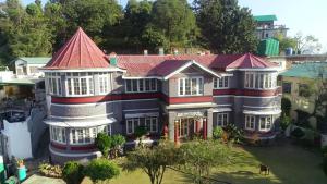 an aerial view of a large house with a red roof at Solan Retreat in Solan