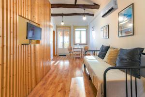 a living room with a couch and a dining room at Fontainhas River Residence in Porto