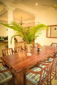 a wooden table with a potted plant on it at Kingfisher Bamboo Garden Villa in Unawatuna