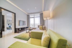 a living room with two beds and a couch at Urban 1BR at DAMAC Celestia B Dubai South by Deluxe Holiday Homes in Dubai