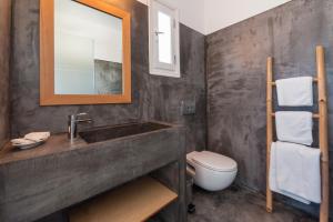 a bathroom with a sink and a toilet at Paros Agnanti Hotel in Parikia