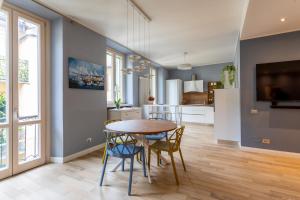 a kitchen and dining room with a table and chairs at Arona Luxury house 50 mt from lake in Arona