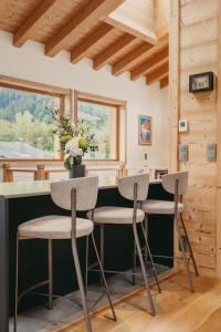 a kitchen with two stools at a counter in a cabin at Chalet Isabella : cozy & comfy in central Chamonix in Chamonix