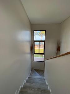 an empty hallway with a window and a staircase at Fazenda Xaréu in Maragogi