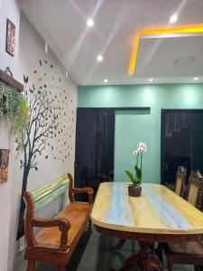 a dining room with a wooden table and two chairs at Casa Lunna Paraty - Praia e cachoeira in Paraty