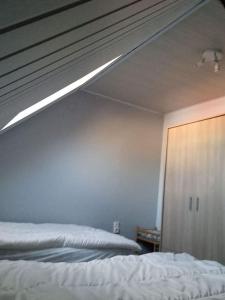 a bedroom with a bed with a cat on the ceiling at Maison de vacances à Cayeux-sur-Mer in Cayeux-sur-Mer