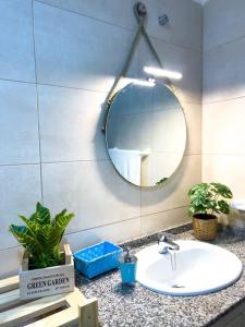 a bathroom counter with a sink and a mirror at Cosy apartment near the beach in Arinaga