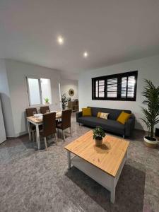 a living room with a couch and a table at Cosy apartment near the beach in Arinaga