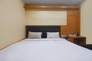 a bedroom with a large white bed in a room at Via Ganpati 2 - Nr Siliguri Junction in Siliguri
