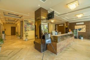 a lobby of a hotel with a reception counter at Moustache Rishikesh Luxuria in Rishīkesh