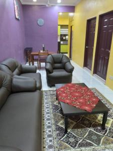 a living room with a couch and a coffee table at D'illahs Homestay in Alor Setar