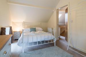 a bedroom with a white bed in a room at Brambles Farm in Leek