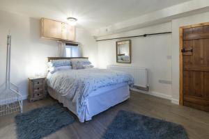 a bedroom with a bed with a blue comforter at Brambles Farm in Leek