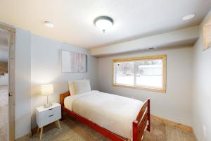 a small bedroom with a bed and a window at Mission Getaway in Spokane Valley