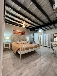 a bedroom with a large bed and a wooden floor at House&Colosseum in Rome