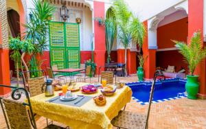a table with food on it in a courtyard at Riad le dromadaire bleu by Weekome in Marrakesh