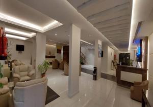 a lobby with couches and chairs in a building at Raoum Inn Majmaa in Al Majma'ah