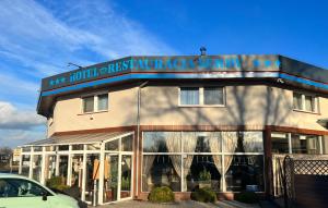 a building with a sign on the front of it at Hotel Serby in Głogów