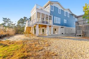 a large blue house with a deck and stairs at Town of Bethany Beach --- 220 4th Street in Bethany Beach