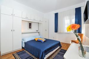 a bedroom with a bed and a vase with a flower at Apartment in Poljana with sea view, terrace, air conditioning, WiFi 3617-1 in Poljana