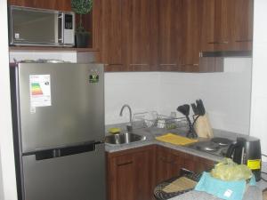 a kitchen with a stainless steel refrigerator and a sink at Apartment Las Heras in Santiago