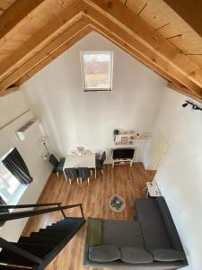 an attic room with a couch and a table at Kuća za odmor ASTREA in Zaton