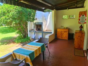 a room with a table and chairs in a house at Otters' Haunt Eco Retreat in Parys