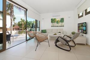 a living room with chairs and a table and a couch at Villa Regina in Ayia Napa