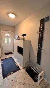 a living room with a fireplace and a door at Ferienwohnung am Kormoranweg in Dorum Neufeld