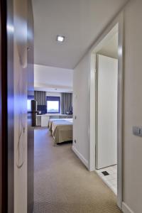 Postel nebo postele na pokoji v ubytování Ramada Plaza by Wyndham Bucharest Convention Center