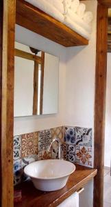 a bathroom with a sink and a mirror at Camino & Piedra - Cabaña de Montaña in Potrerillos