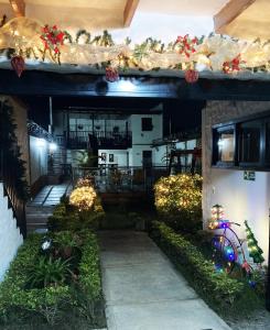 a house with a porch with christmas lights at Hotel Boutique Colonial Cartago in Cartago