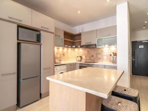 a kitchen with stainless steel appliances and a counter top at Mandela Place Apartment in Cape Town +9 photos