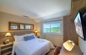 Cama o camas de una habitación en Quarto/Apartamento no Wyndham Gramado Termas Resort