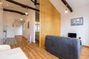 a living room with a couch and a table at Fontainhas River Residence in Porto