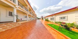 an empty courtyard of a building with plants at Maya Villa in Oyibi