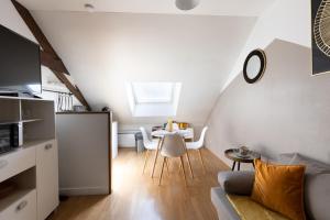 a living room with a couch and a table at L'appart K-shmire- Cosy et spacieux, 4 pers in Le Mans +7 photos