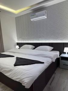 two beds in a hotel room with a air conditioner at privet (37)near downtown kh&sh in Ash Shumaysānī