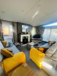 a living room with a couch and a fireplace at Laburnum Lodge with Hot Tub in York