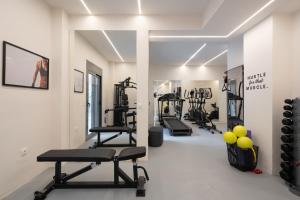 a gym with several tread machines in a room at IO SUITES in Athens