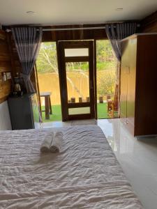 a pair of slippers sitting on a bed in a room at Floor river view in Cat Tien