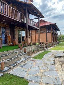 a house with a stone path in front of it at Floor river view in Cat Tien